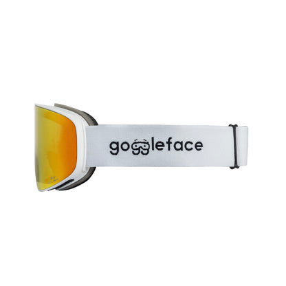 A side view of the Straight Line | White Snow Goggles, featuring a white strap with "Goggleface" in black letters and a small logo resembling a pair of goggles. The yellow-orange tinted lenses are perfect for hitting the slopes.
